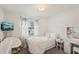 This bedroom is bright and airy, with soft textures and delicate floral accents at 1421 Buckner Rd, Valrico, FL 33596