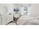 Bright bedroom with plush white accents, cozy chair, and decorative floral curtains at 1421 Buckner Rd, Valrico, FL 33596