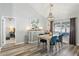 Charming dining room with a statement chandelier, stylish furnishings, and wood-look flooring at 1421 Buckner Rd, Valrico, FL 33596