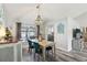 Charming dining room with a statement chandelier, stylish furnishings, and wood-look flooring at 1421 Buckner Rd, Valrico, FL 33596