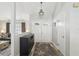 Bright entryway featuring stylish decor, a statement chandelier, a decorative table, and wood-look flooring at 1421 Buckner Rd, Valrico, FL 33596