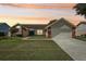 Charming single-Gathering home with a well-manicured lawn, brick accents, and an attached two-car garage at 1421 Buckner Rd, Valrico, FL 33596