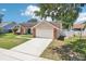 Charming single-story home with a two-car garage, brick accents, and a well-kept front lawn at 1421 Buckner Rd, Valrico, FL 33596