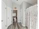 Hallway with wood-look flooring, with easy access to the bathroom and bedroom at 1421 Buckner Rd, Valrico, FL 33596