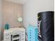 Bright workout space features a modern white desk, blue dresser and Everlast heavy bag for your exercise needs at 1421 Buckner Rd, Valrico, FL 33596