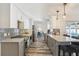 Bright kitchen with white cabinets, gray backsplash, and island seating at 1421 Buckner Rd, Valrico, FL 33596