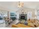 Cozy living room with a decorative fireplace, stylish furniture, a ceiling fan, and wood-look flooring at 1421 Buckner Rd, Valrico, FL 33596