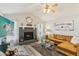 Cozy living room with a decorative fireplace, stylish furniture, a ceiling fan, and wood-look flooring at 1421 Buckner Rd, Valrico, FL 33596