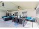 Covered patio featuring outdoor dining and seating areas with ceiling fans at 1421 Buckner Rd, Valrico, FL 33596