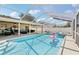 Inviting screened-in pool area with a sparkling pool, lounge seating, and covered patio, ideal for relaxation and entertainment at 1421 Buckner Rd, Valrico, FL 33596