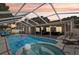 Inviting pool area with screened enclosure, spa and covered patio at 1421 Buckner Rd, Valrico, FL 33596