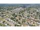 Bird's eye view of homes nestled among lush trees, highlighting neighborhood shopping center nearby at 1450 Seabreeze St, Clearwater, FL 33756