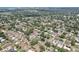 An overhead view shows a neighborhood of charming homes with pools, mature trees, and solar panels at 1450 Seabreeze St, Clearwater, FL 33756