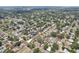 Overhead shot showcasing a residential area with tree-lined streets and various home styles at 1450 Seabreeze St, Clearwater, FL 33756