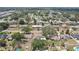 Aerial view of homes with solar panels, surrounded by well-maintained yards and mature trees at 1450 Seabreeze St, Clearwater, FL 33756
