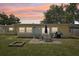 Back yard highlighting a patio set, grill, and fire pit, designed for enjoyable outdoor living and entertainment at 1450 Seabreeze St, Clearwater, FL 33756