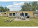 The home's backyard features a brick patio, outdoor seating, heat lamp and fire pit area at 1450 Seabreeze St, Clearwater, FL 33756