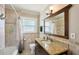 Well-lit bathroom featuring neutral tile, granite countertop vanity, and shower-tub combination with updated finishes at 1450 Seabreeze St, Clearwater, FL 33756