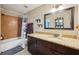 Bathroom featuring granite countertop, dark cabinets, and shower-tub combination, designed for comfort and convenience at 1450 Seabreeze St, Clearwater, FL 33756