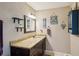 Stylish bathroom with granite countertop vanity and nautical decorations, blending functionality with coastal charm and ample space at 1450 Seabreeze St, Clearwater, FL 33756