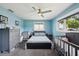Bright bedroom with ample natural light, a ceiling fan, and neutral grey carpeting throughout the space at 1450 Seabreeze St, Clearwater, FL 33756
