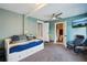 Comfortable bedroom with a trundle bed, ceiling fan, and a view into the ensuite bathroom at 1450 Seabreeze St, Clearwater, FL 33756