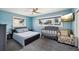 Bedroom featuring a bed, crib, chair, television and window for natural light and a ceiling fan for temperature control at 1450 Seabreeze St, Clearwater, FL 33756
