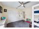 Bright bedroom featuring a ceiling fan, carpet, and a closet with sliding doors, perfect for a room at 1450 Seabreeze St, Clearwater, FL 33756