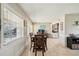 Bright dining area features wainscoting, large windows, and tile flooring at 1450 Seabreeze St, Clearwater, FL 33756