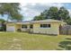 Well-maintained single-story home with solar panels and a lush lawn, complemented by a convenient driveway at 1450 Seabreeze St, Clearwater, FL 33756