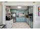 Kitchen with blue cabinetry, stainless steel appliances, and stone countertops at 1450 Seabreeze St, Clearwater, FL 33756
