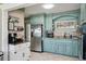 Charming kitchen with custom blue cabinets and stainless steel appliances at 1450 Seabreeze St, Clearwater, FL 33756