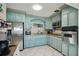 Bright kitchen featuring custom blue cabinetry, stainless appliances and granite countertops at 1450 Seabreeze St, Clearwater, FL 33756