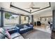 Open-concept living room with ample natural light, tile floors, and plush blue seating at 1450 Seabreeze St, Clearwater, FL 33756
