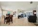 Bright, open-concept living space with tile floors connecting the living room, dining area, and office space at 1450 Seabreeze St, Clearwater, FL 33756
