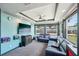 Cozy living room with plush blue seating, tv, a ceiling fan and plenty of natural light at 1450 Seabreeze St, Clearwater, FL 33756