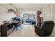 Cozy living room with a desk, adjacent sitting area, and tile floors at 1450 Seabreeze St, Clearwater, FL 33756