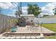This backyard features a large wooden deck area and a play house shed at 1450 Seabreeze St, Clearwater, FL 33756