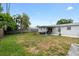 Lush backyard with a covered patio and a shed at 1489 77Th N Ave, St Petersburg, FL 33702