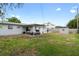 Large backyard featuring a storage shed and covered patio with ample space for outdoor activities at 1489 77Th N Ave, St Petersburg, FL 33702
