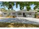 Charming single-story home with a well-maintained front yard, a cozy porch, and a spacious driveway at 1489 77Th N Ave, St Petersburg, FL 33702