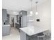 Modern kitchen with sleek gray cabinets, stainless steel appliances, and a convenient breakfast bar with seating at 1489 77Th N Ave, St Petersburg, FL 33702