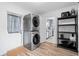 Convenient laundry area with stacked washer/dryer and shelving for storage and easy access to kitchen at 1489 77Th N Ave, St Petersburg, FL 33702