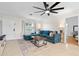 Spacious living room featuring a comfortable blue sectional sofa, a stylish coffee table, and a large window at 1489 77Th N Ave, St Petersburg, FL 33702