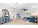 Bright living room with modern decor, a blue sofa, entertainment center, and a stylish arch mirror at 1489 77Th N Ave, St Petersburg, FL 33702