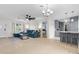 Open-concept living area seamlessly connects the living room, dining area, and modern kitchen with a breakfast bar at 1489 77Th N Ave, St Petersburg, FL 33702