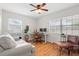 Stylish home office with hardwood floors, a comfortable couch and plenty of natural light at 1489 77Th N Ave, St Petersburg, FL 33702