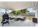 Covered patio with comfortable seating and grill, perfect for outdoor dining and entertaining at 1489 77Th N Ave, St Petersburg, FL 33702