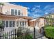 Backyard patio with a dining set, an umbrella, lush greenery, and multiple entry points to the property at 1515 Park N St, St Petersburg, FL 33710