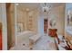 Luxury bathroom with a soaking tub, walk-in shower, and vanity with an ornate mirror at 1515 Park N St, St Petersburg, FL 33710